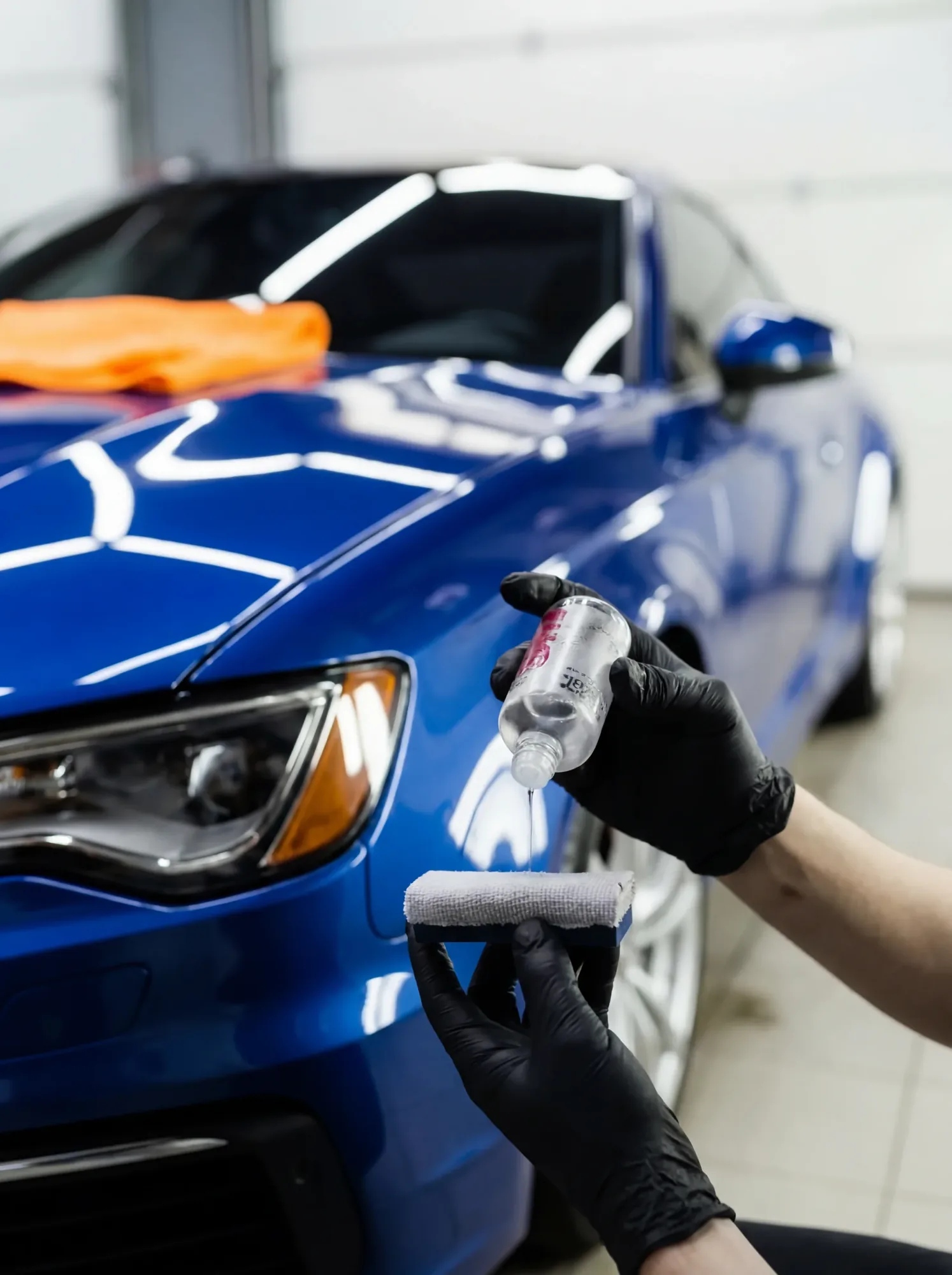 System X ceramic coating being applied to blue vehicle, Lake Geneva Detailing professional application
